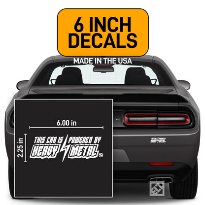 White 6 inch "This Car is Powered by Heavy Metal" vinyl decal on a dark gray Dodge Challenger.