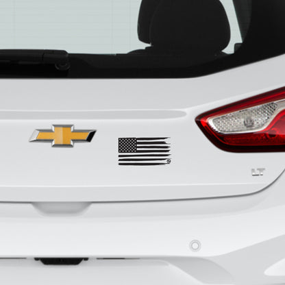 Black distressed American flag on the back of a white car
