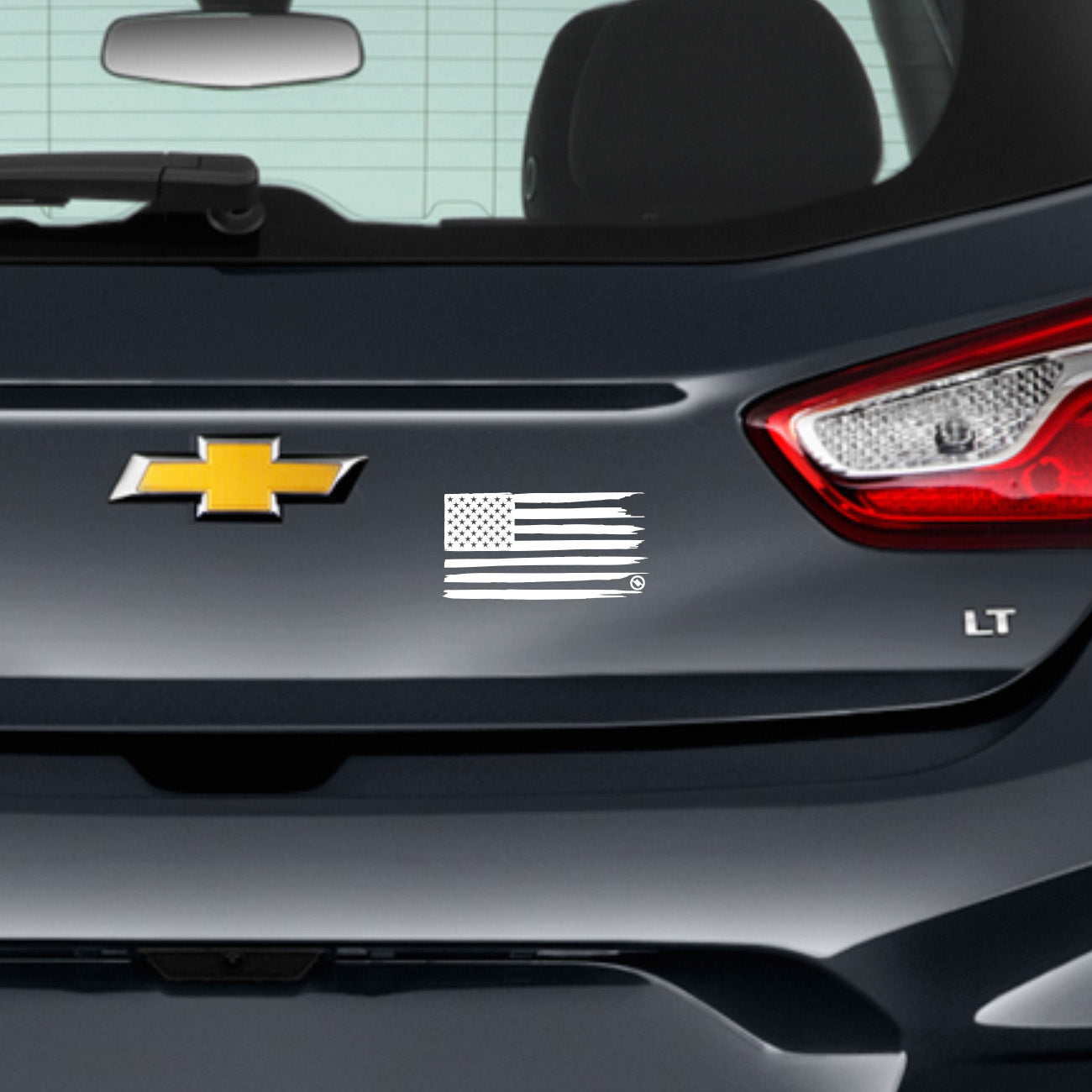 White distressed American flag on the back of a dark gray car